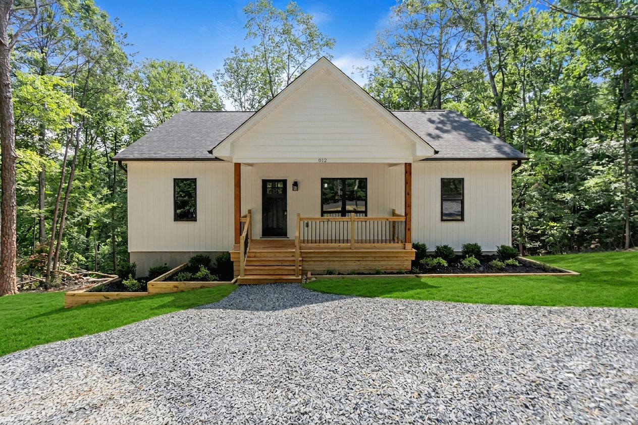 Front of the Hillcrest at Woodrun custom home with a covered porch and gravel drive in Mt. Gilead, NC