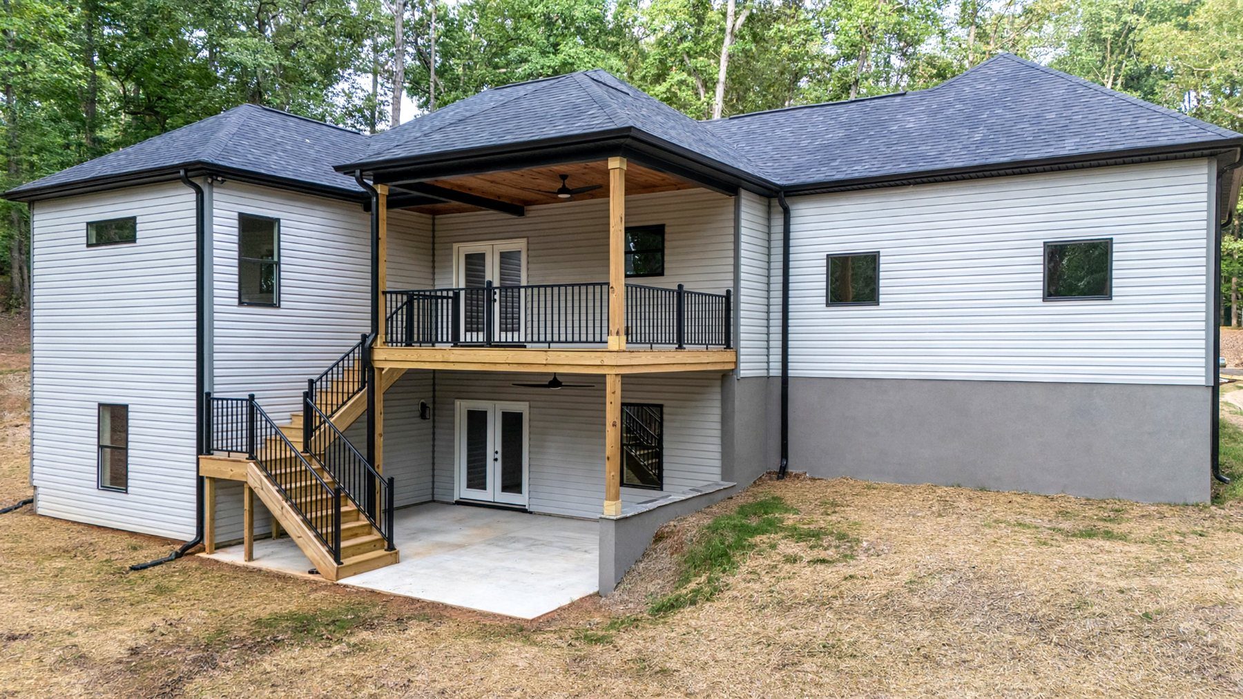 Rear of the Raven's Ridge home with a two-level covered deck and walkout basement