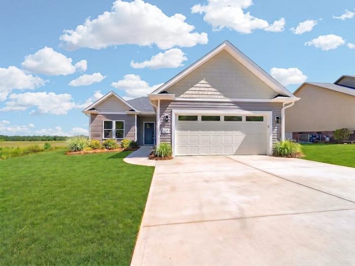 Front of a single-story custom home with a two-car garage and covered porch